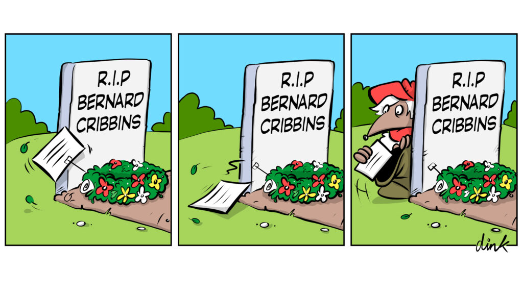 Womble picks up a card from a wreath on Bernard Cribbins' graveside.